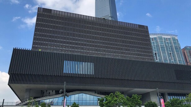 A modern building with a prominent sloped roof and a large, rectangular facade. - Holiday Inn Golden Mile Hong Kong by IHG (Kowloon)