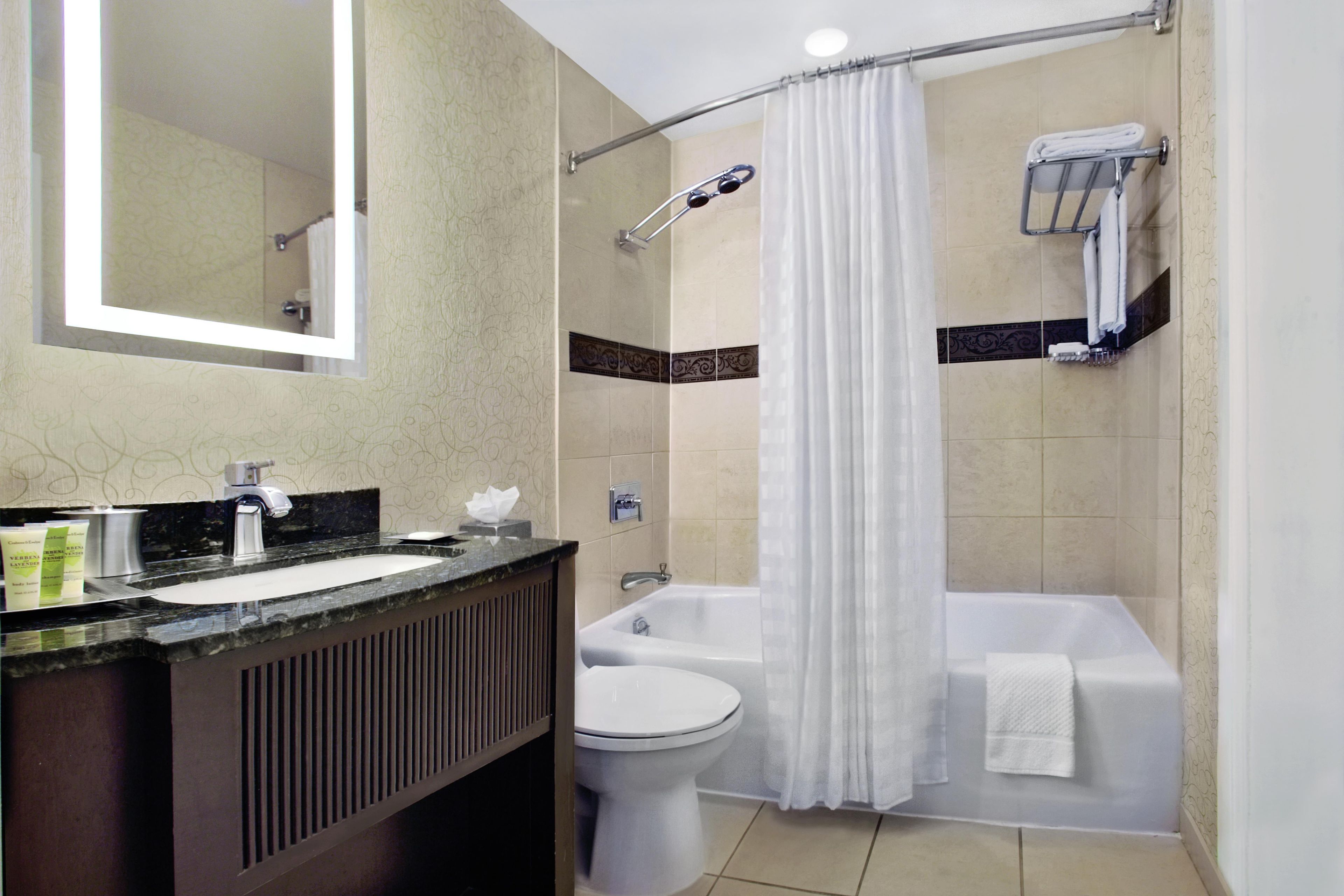 A bathroom with a sink, toilet, shower, and bathtub.