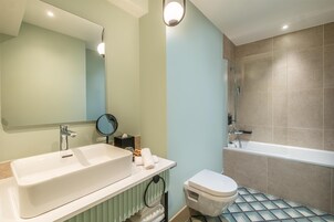 A bathroom with a sink, toilet, and bathtub.