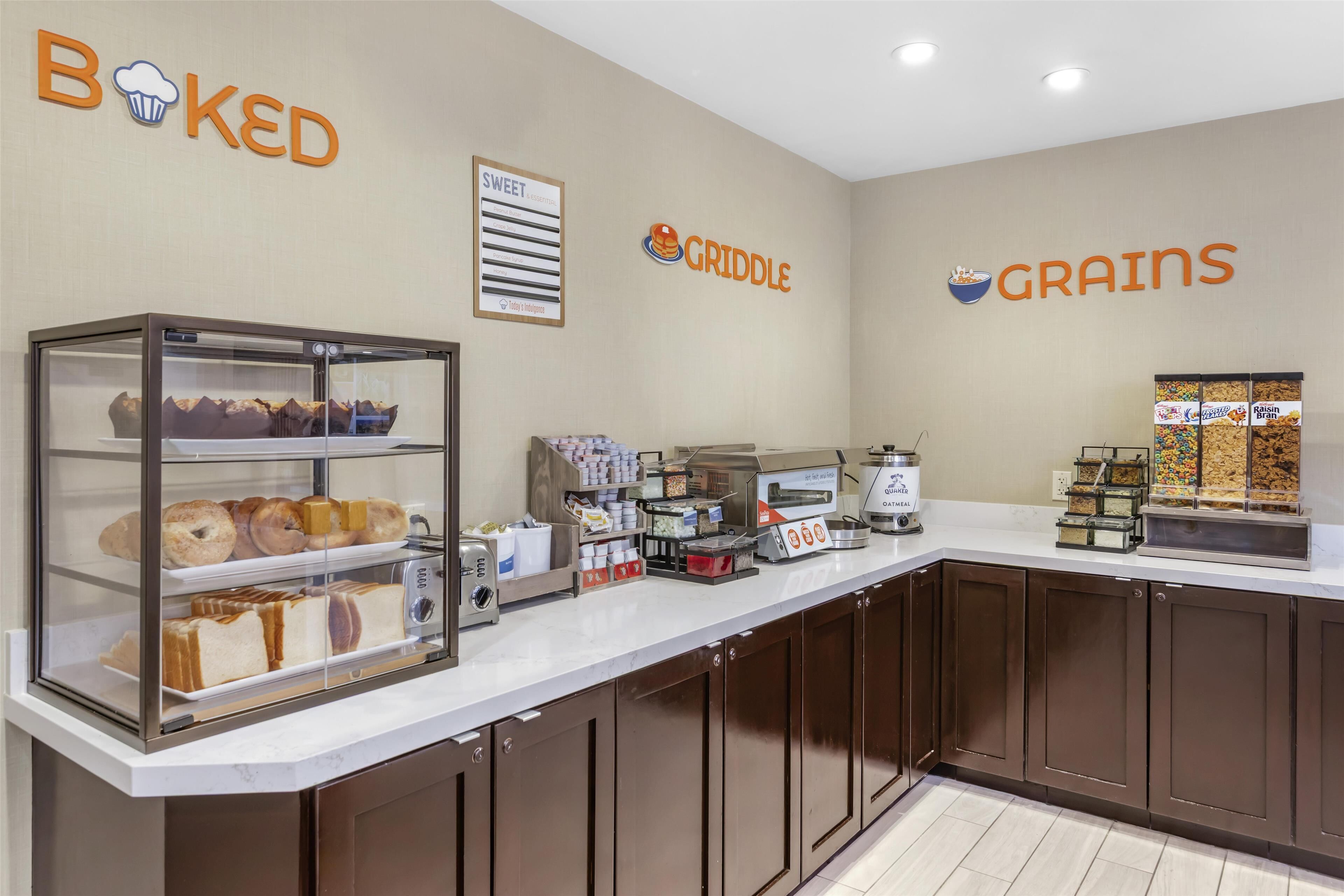 A bakery counter with various baked goods and a coffee machine.
