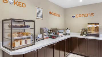 A bakery counter with various baked goods and a coffee machine.