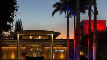 A modern hotel with a curved facade, a prominent entrance, and a visible sign reading "MERIDEN".