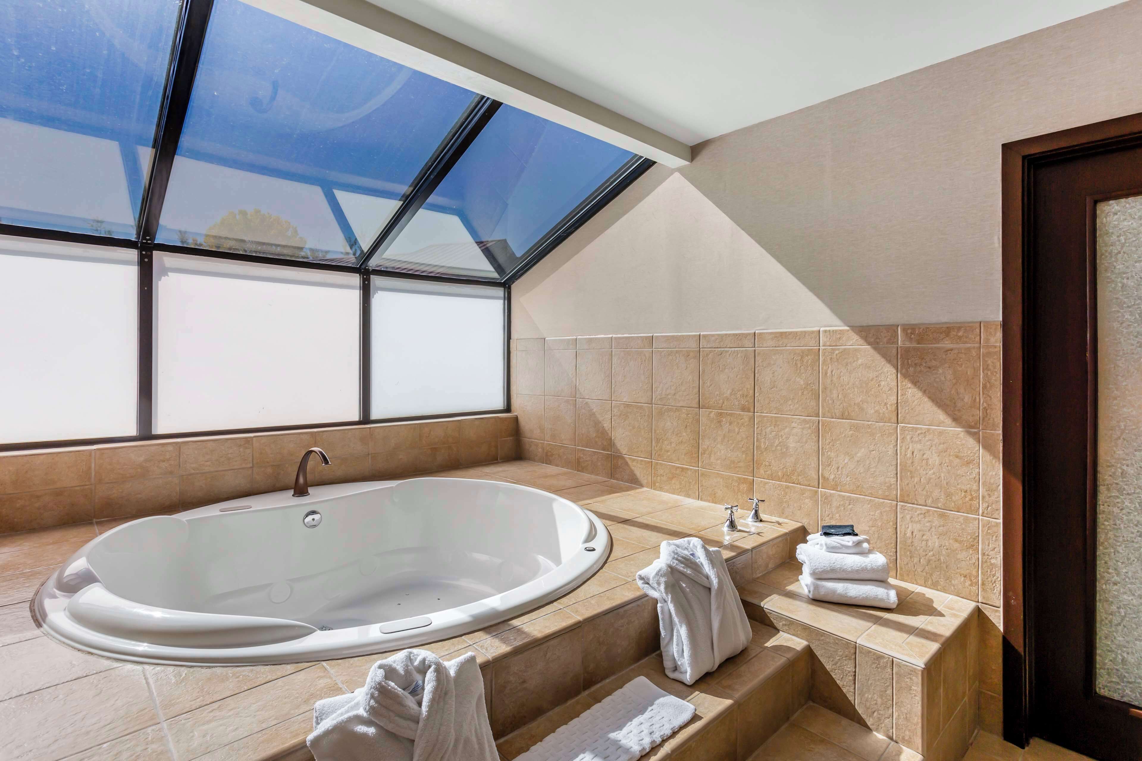 suite, 1 king bed, non smoking, hot tub | bathroom | combined shower/bathtub, eco-friendly toiletries, hair dryer, towels