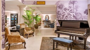 A grand lobby with a piano, plush seating, and a 'CIN CIN' sign. - Fairmont The Norfolk (Nairobi)