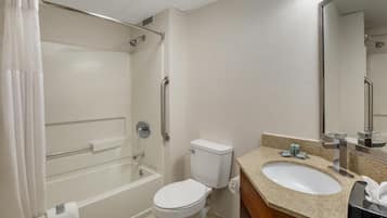 Un baño con bañera, inodoro, lavabo y espejo.