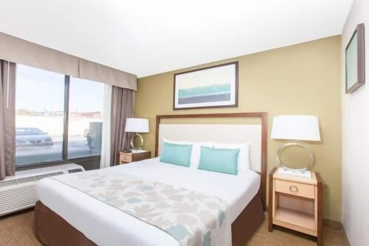 Premium bedding, desk, laptop workspace, blackout drapes
