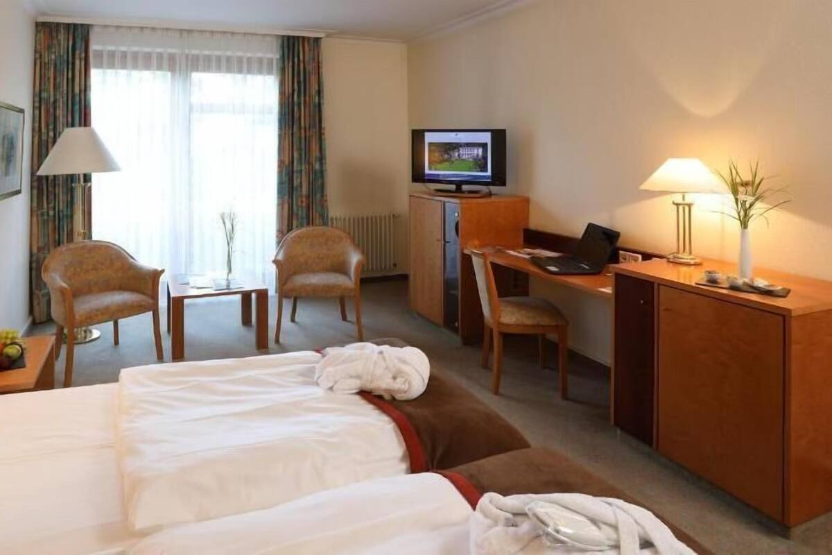 Ropa de cama hipoalergénica y caja de seguridad en la habitación