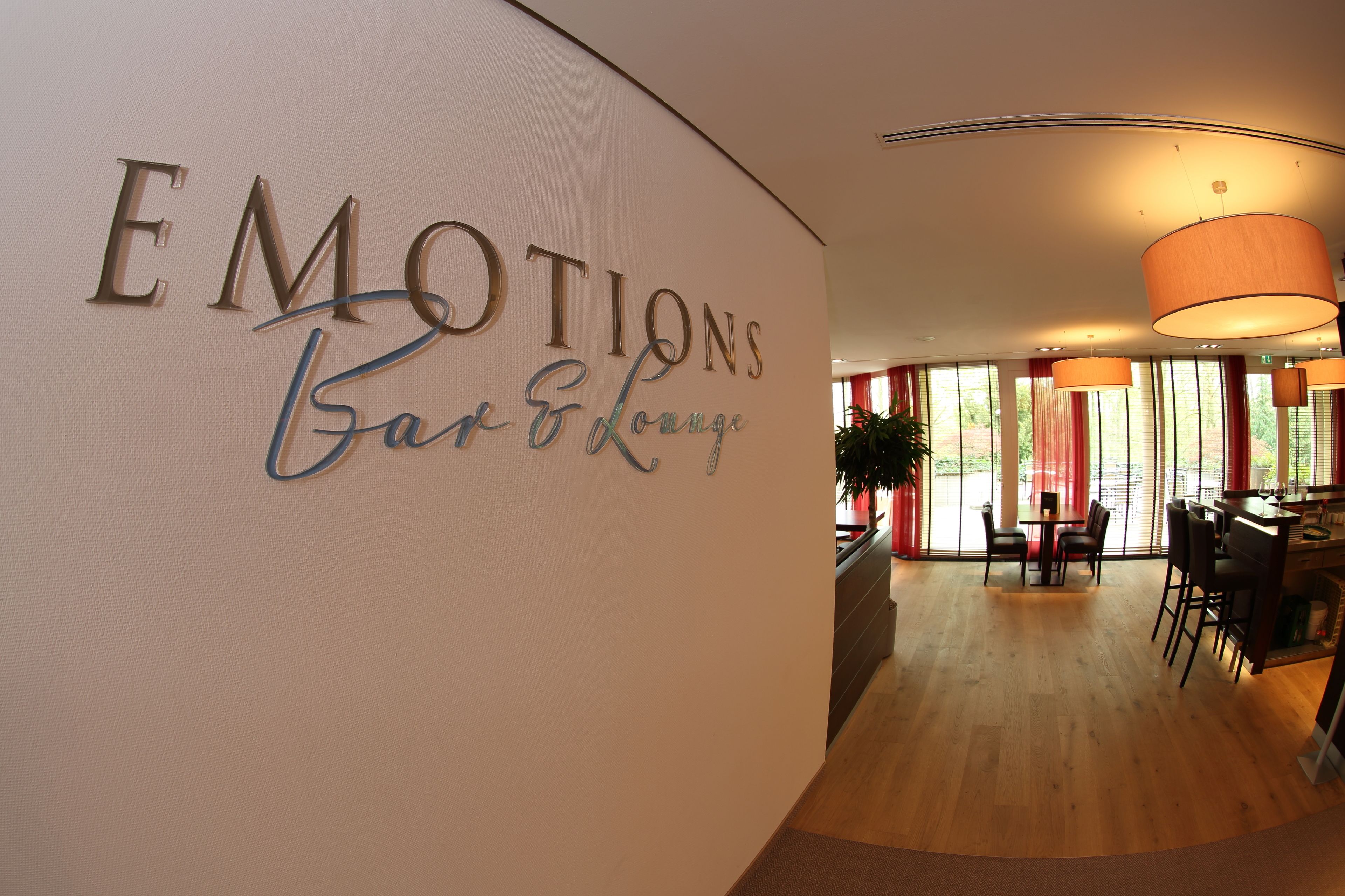 A bar/lounge area with a sign reading "EMOTIONS Bar & Lounge".