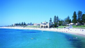 A coastal hotel with a beach view, multiple swimming areas, and a large building with a dome. - Crowne Plaza Perth by IHG (East Perth)