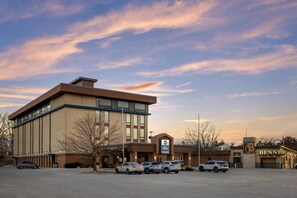 A hotel with a parking lot, a sign for Best Western, and a building with a 'B' logo.