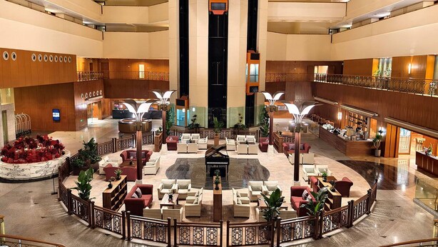 A spacious lobby with a central piano, multiple seating areas, and a grand staircase. - XI’AN DAJING CASTLE HOTEL (Xi'an)