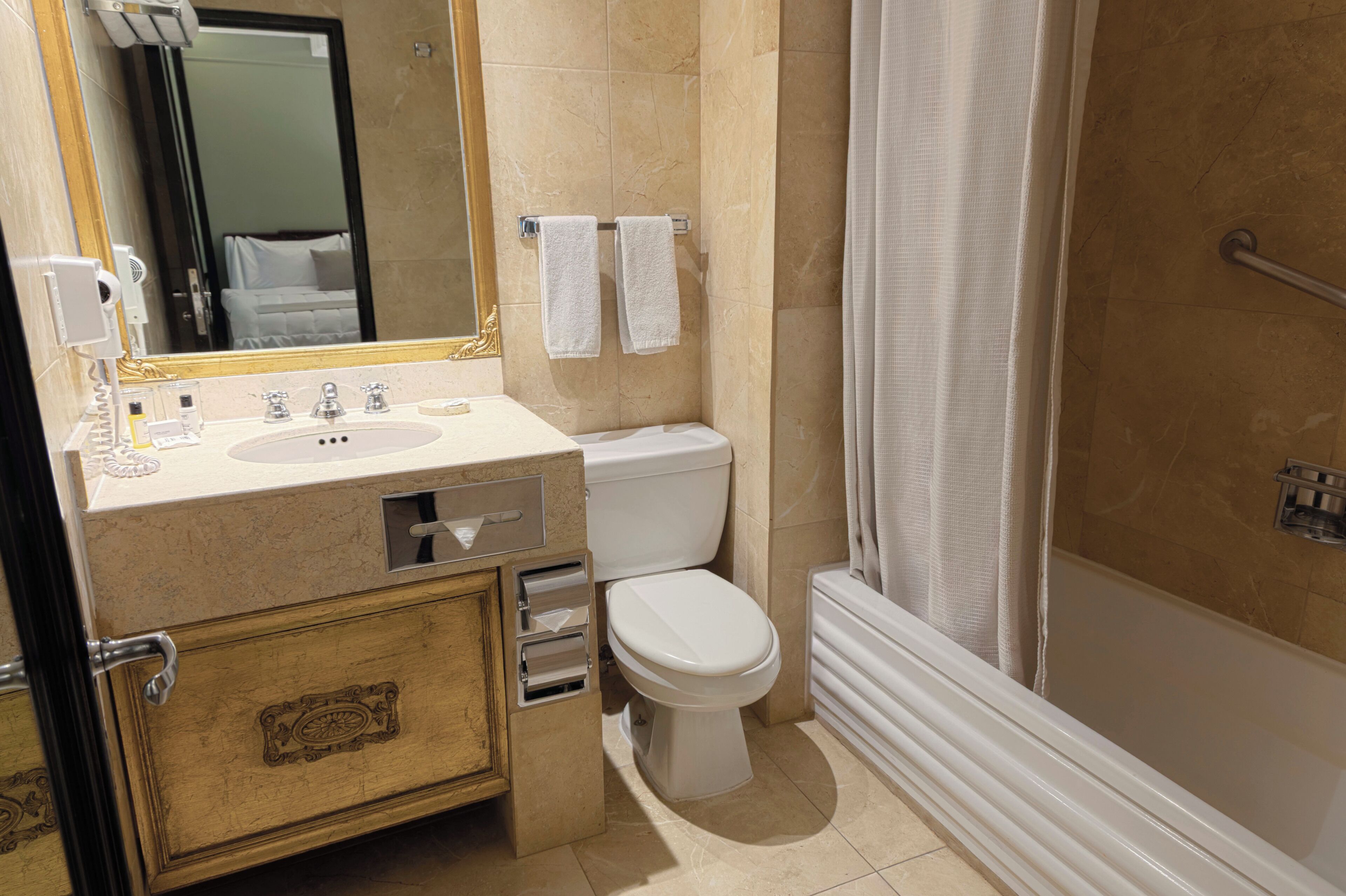 A bathroom with a sink, toilet, and shower.