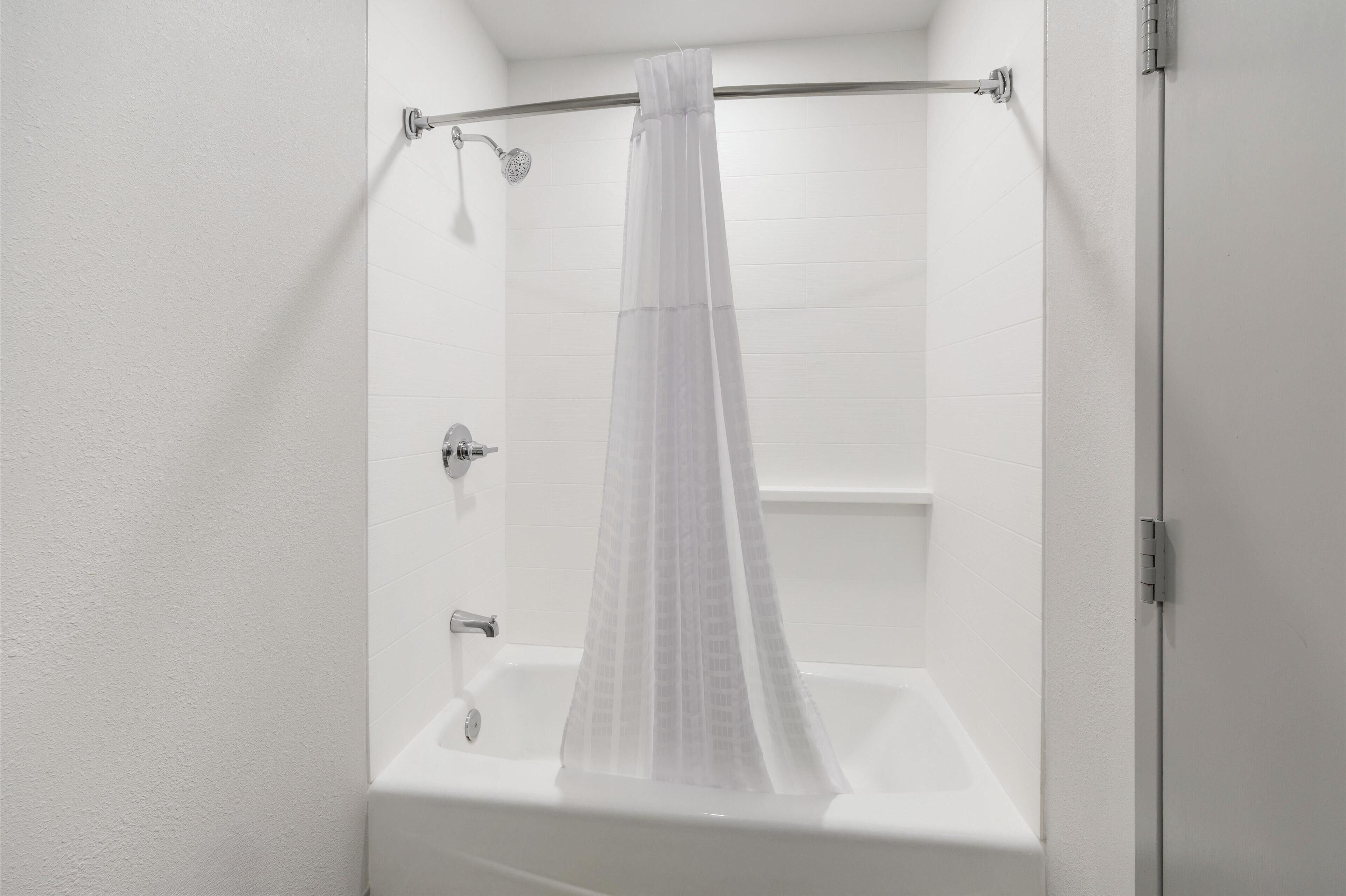 standard room, 1 king bed, non smoking, refrigerator & microwave (larger room;with sofabed) | bathroom | combined shower/bathtub, rainfall showerhead, eco-friendly toiletries