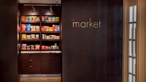 A snack display in a store with shelves stocked with various brands. - Sonesta Select Boston Danvers (Danvers)