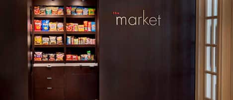 A snack display in a store with shelves stocked with various brands.