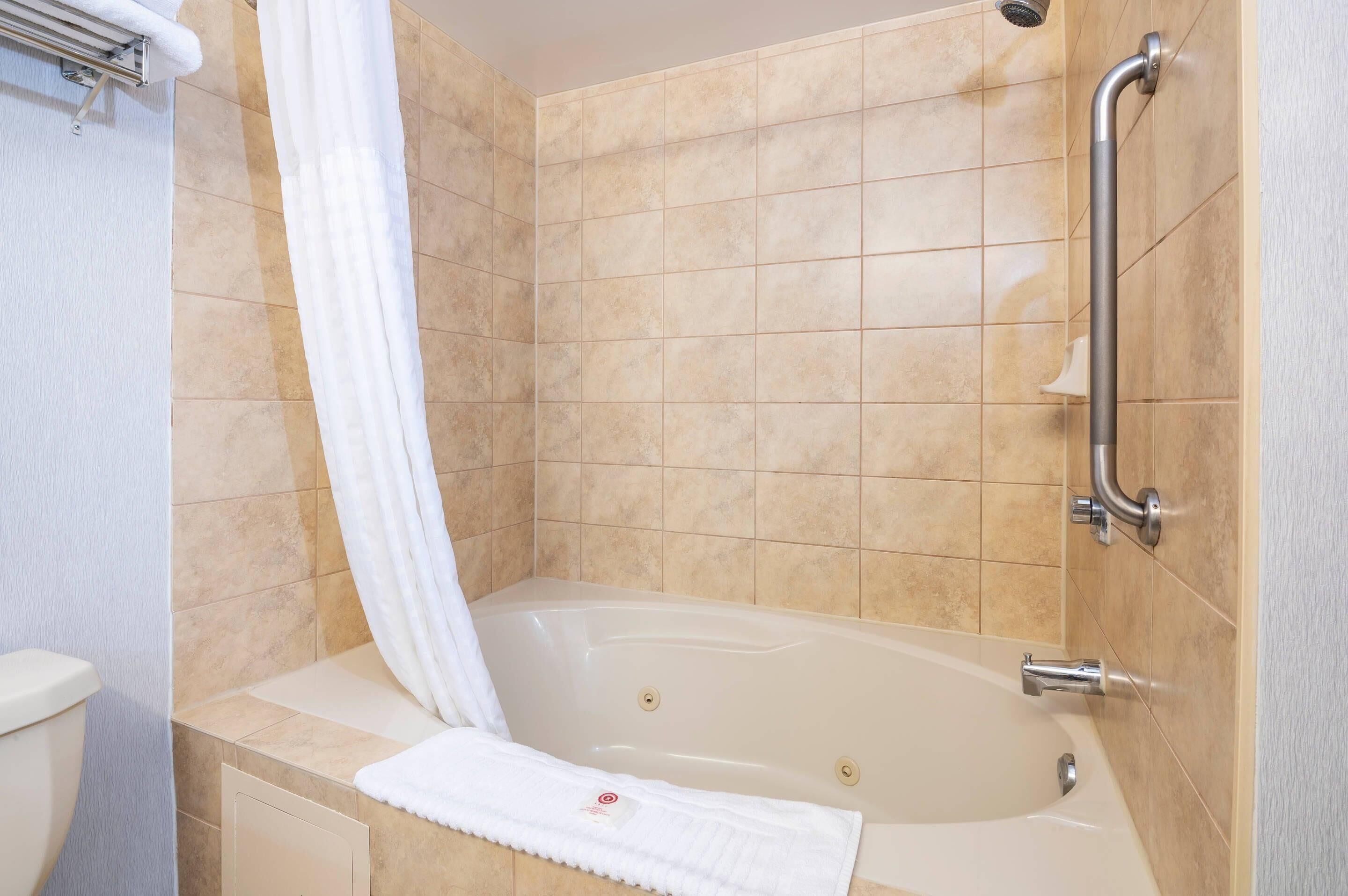 A bathroom with a bathtub, a shower, and a toilet.