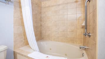 A bathroom with a bathtub, a shower, and a toilet.
