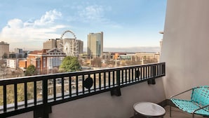 A balcony with a view of a Ferris wheel and city buildings. - The American Hotel Atlanta Downtown, Tapestry Collection by Hilton (Atlanta)