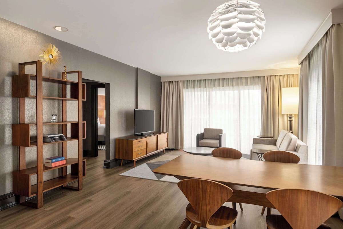 Signature Suite, 1 King Bed, Balcony | Living area | 55-inch flat-screen TV with satellite channels, TV, pay movies