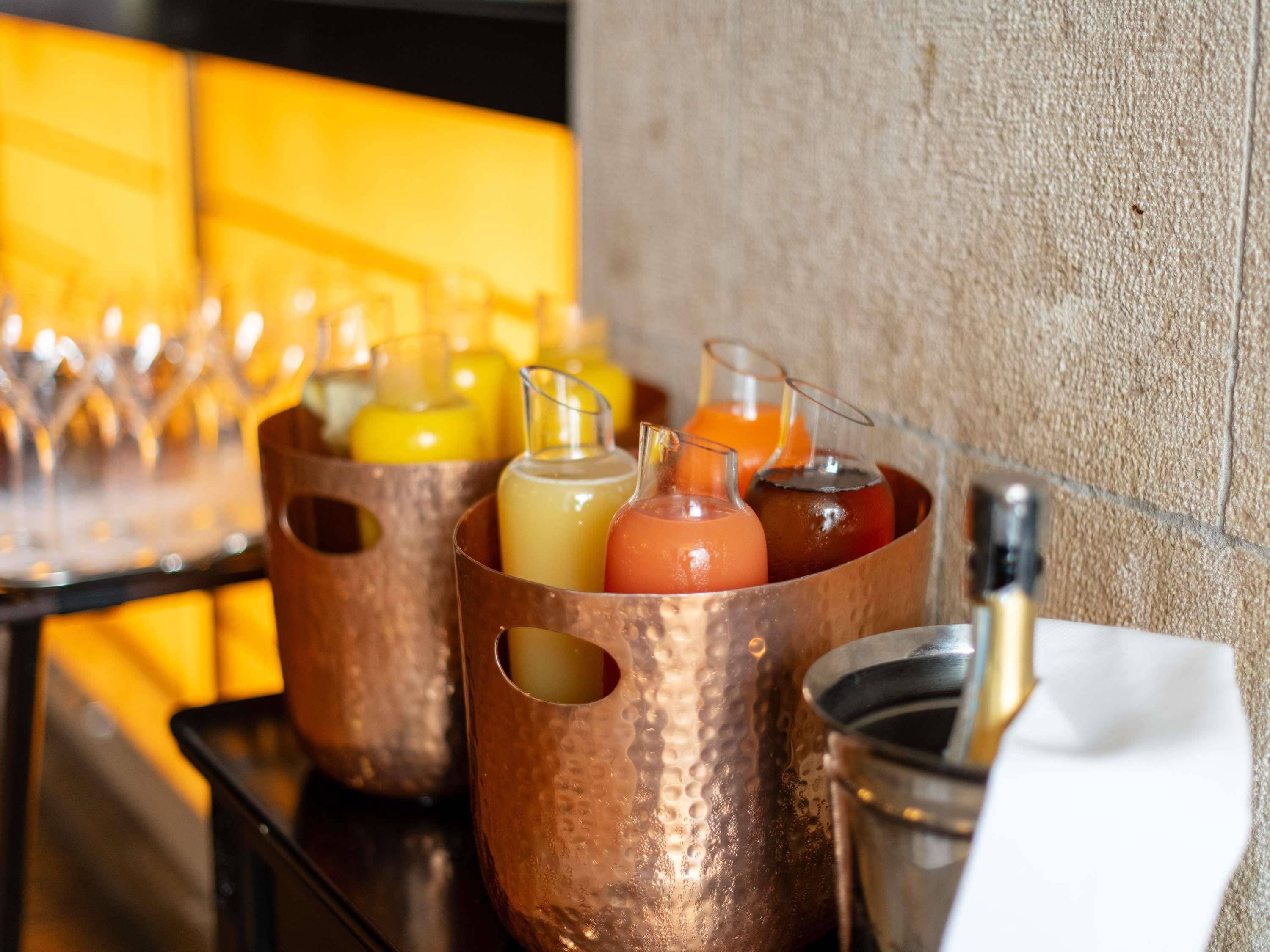 A bar area with copper drink dispensers and glasses.
