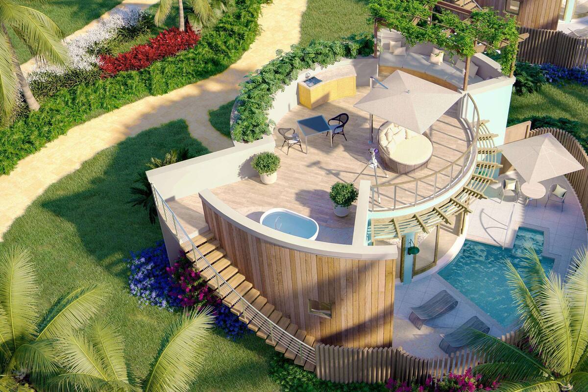 Un complexe hôtelier moderne doté d’une piscine circulaire, d’un espace de détente en plein air et d’un aménagement paysager luxuriant.