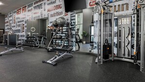 A gym with various exercise equipment, including weight machines and free weights.