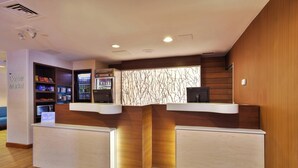 A reception desk with a vending machine and a sign for the corner market. - Fairfield Inn By Marriott Ann Arbor (Ann Arbor)