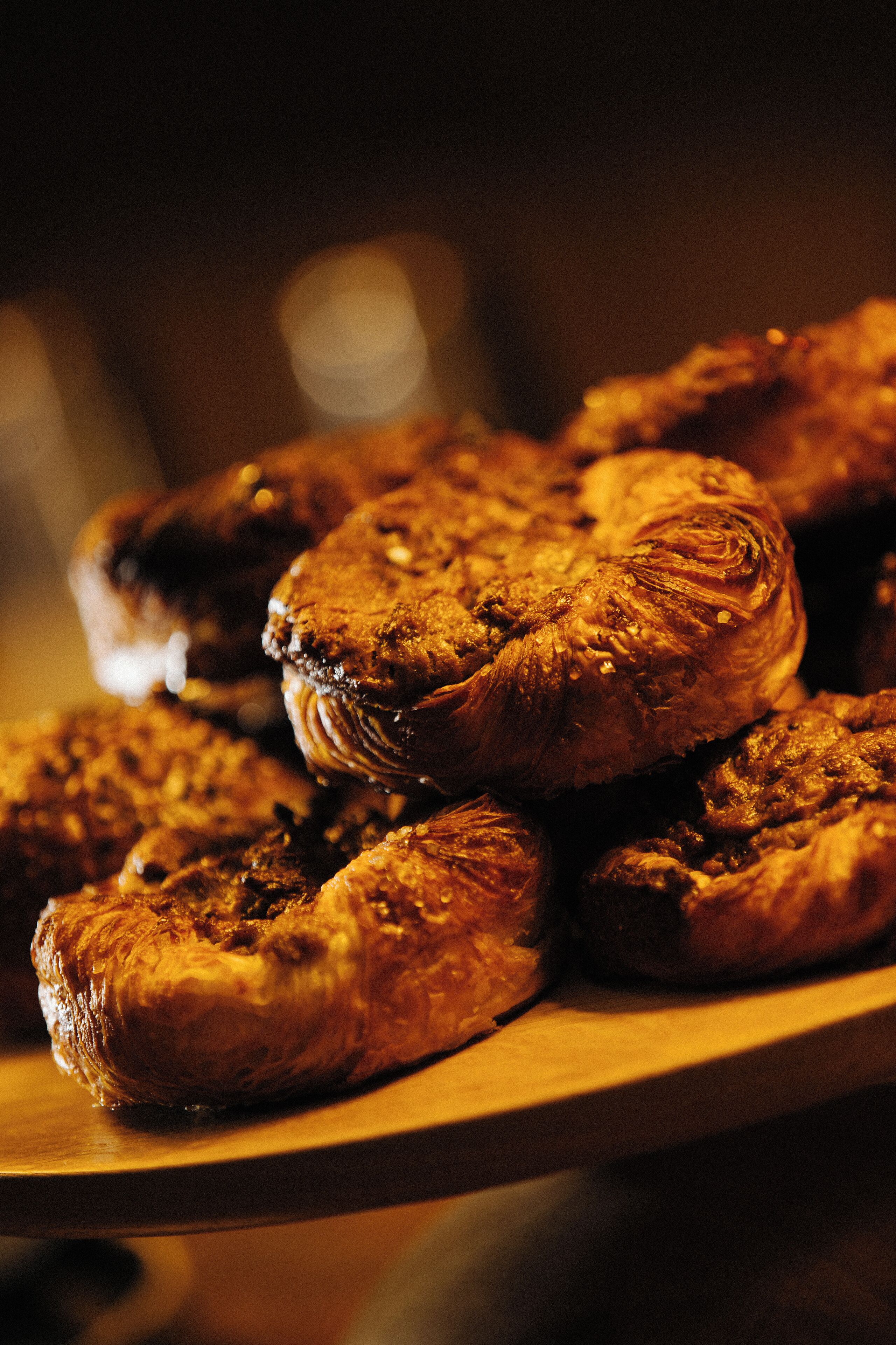 A stack of pastries on a wooden surface.