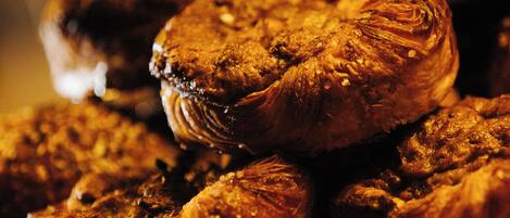 A stack of pastries on a wooden surface.
