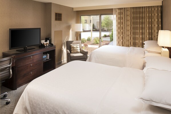 A hotel room with two beds, a television, a desk with a computer, and a chair. - Sheraton Hartford South Hotel (Rocky Hill)