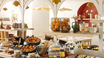 A buffet with various food items and a decorative archway.