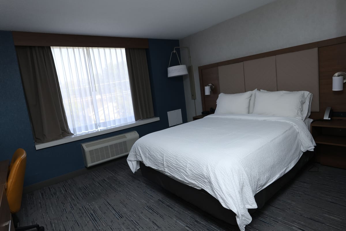 Premium bedding, desk, laptop workspace, blackout drapes