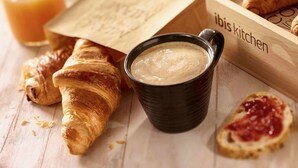 A wooden tray with croissants, a cup of coffee, and a glass of orange juice. - ibis Bourg En Bresse (Bourg-en-Bresse)