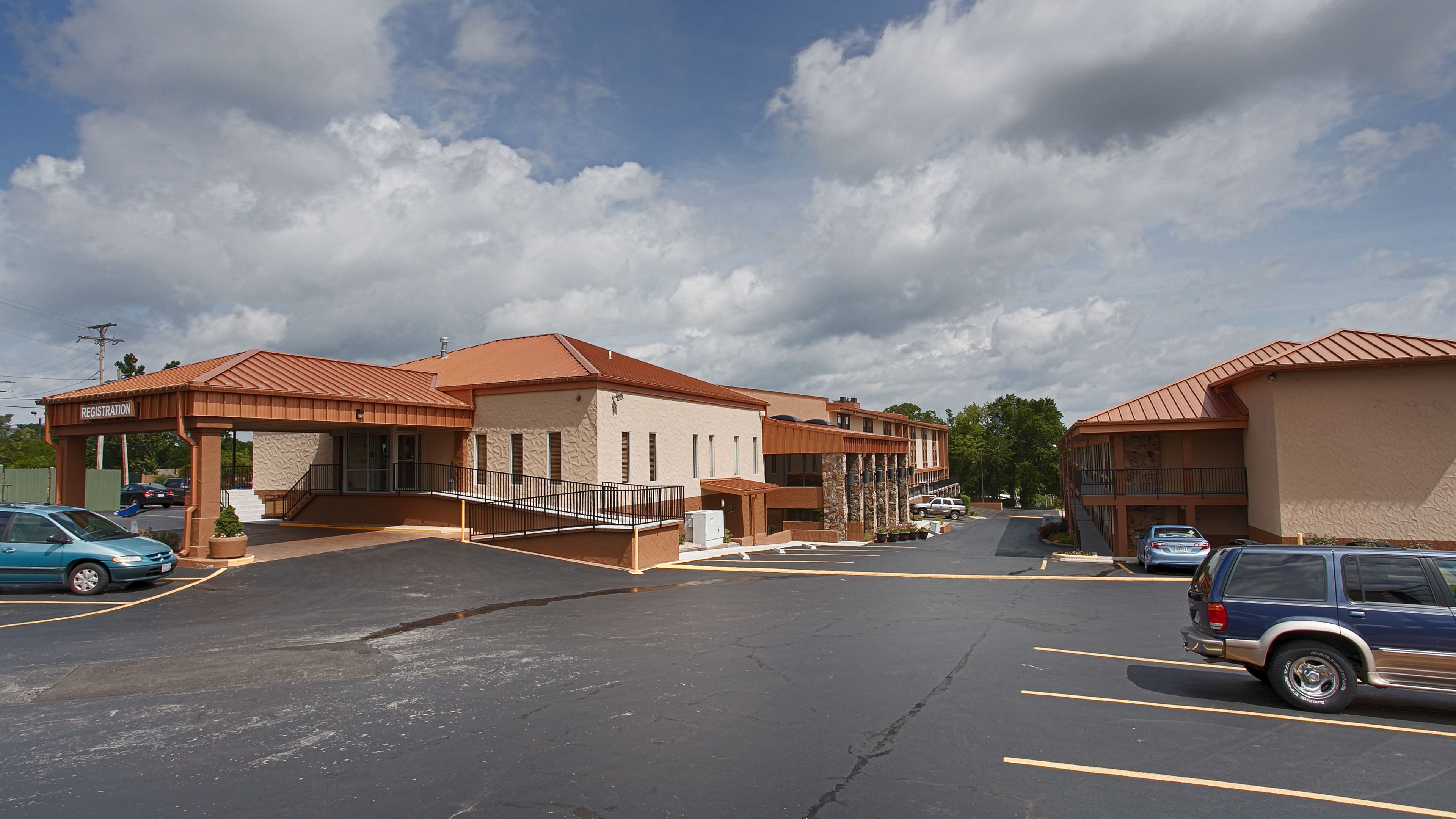 A parking lot with a registration building and a covered area.