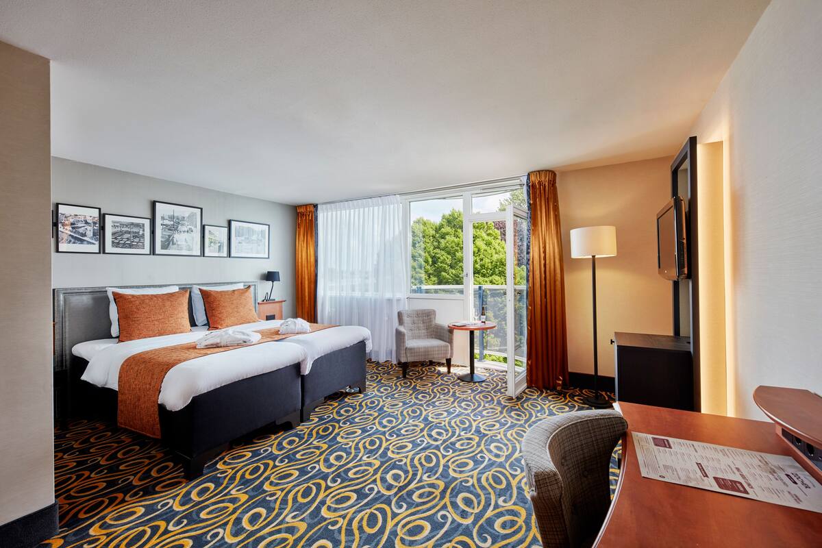 The Deluxe One with a balcony | Premium bedding, memory foam beds, in-room safe, desk