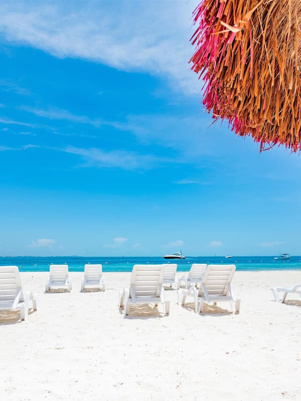 On the beach, white sand, beach umbrellas, beach towels