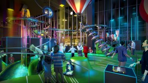 Ein moderner Indoor-Spielbereich mit verschiedenen interaktiven Elementen und einer digitalen Benutzeroberfläche zum Spielen.