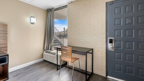 Une pièce avec un bureau, une chaise et une porte.