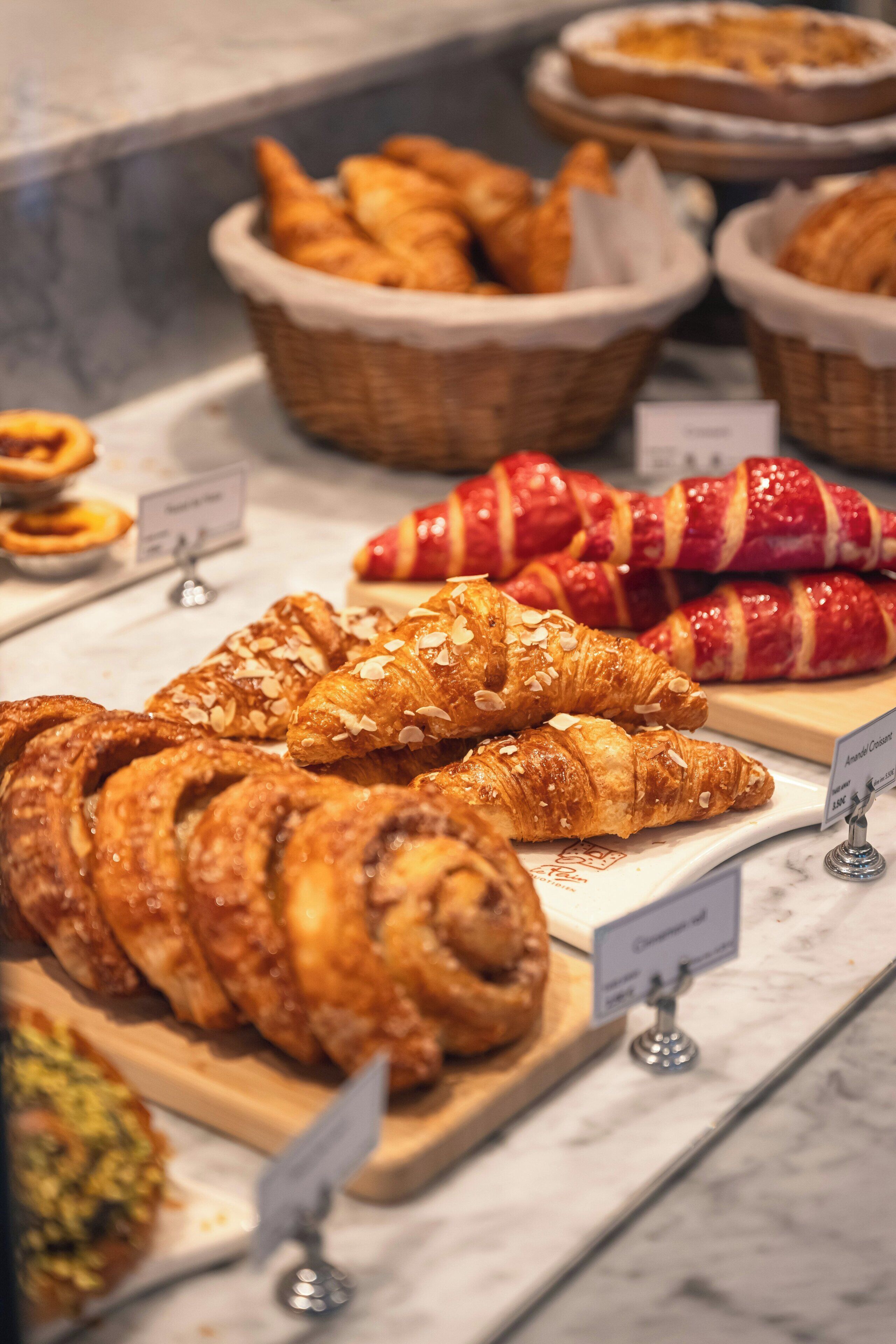 A bakery display with various pastries and bread.