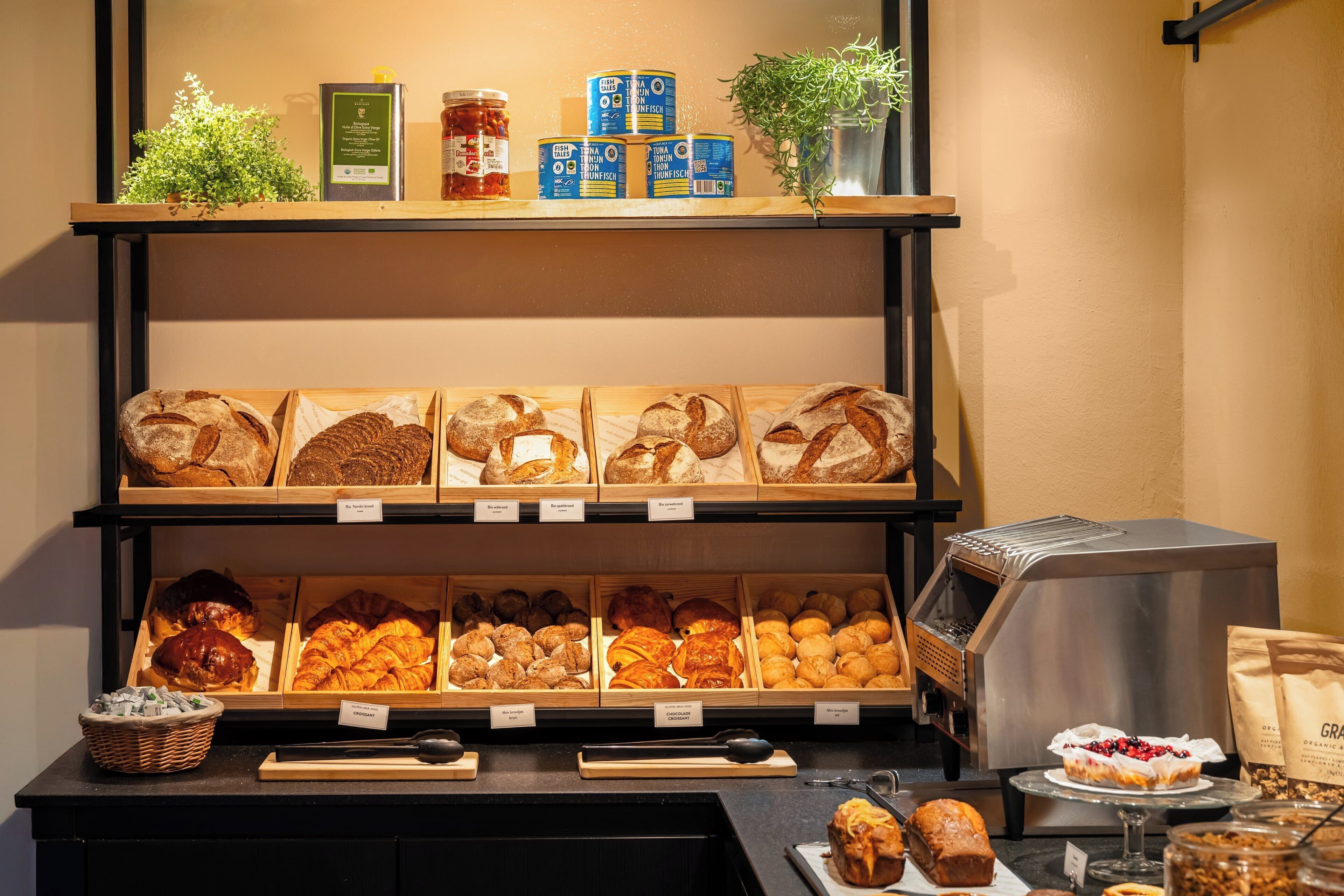 A bakery display with various types of bread and pastries.