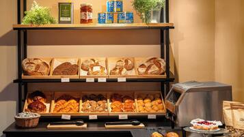 A bakery display with various types of bread and pastries.