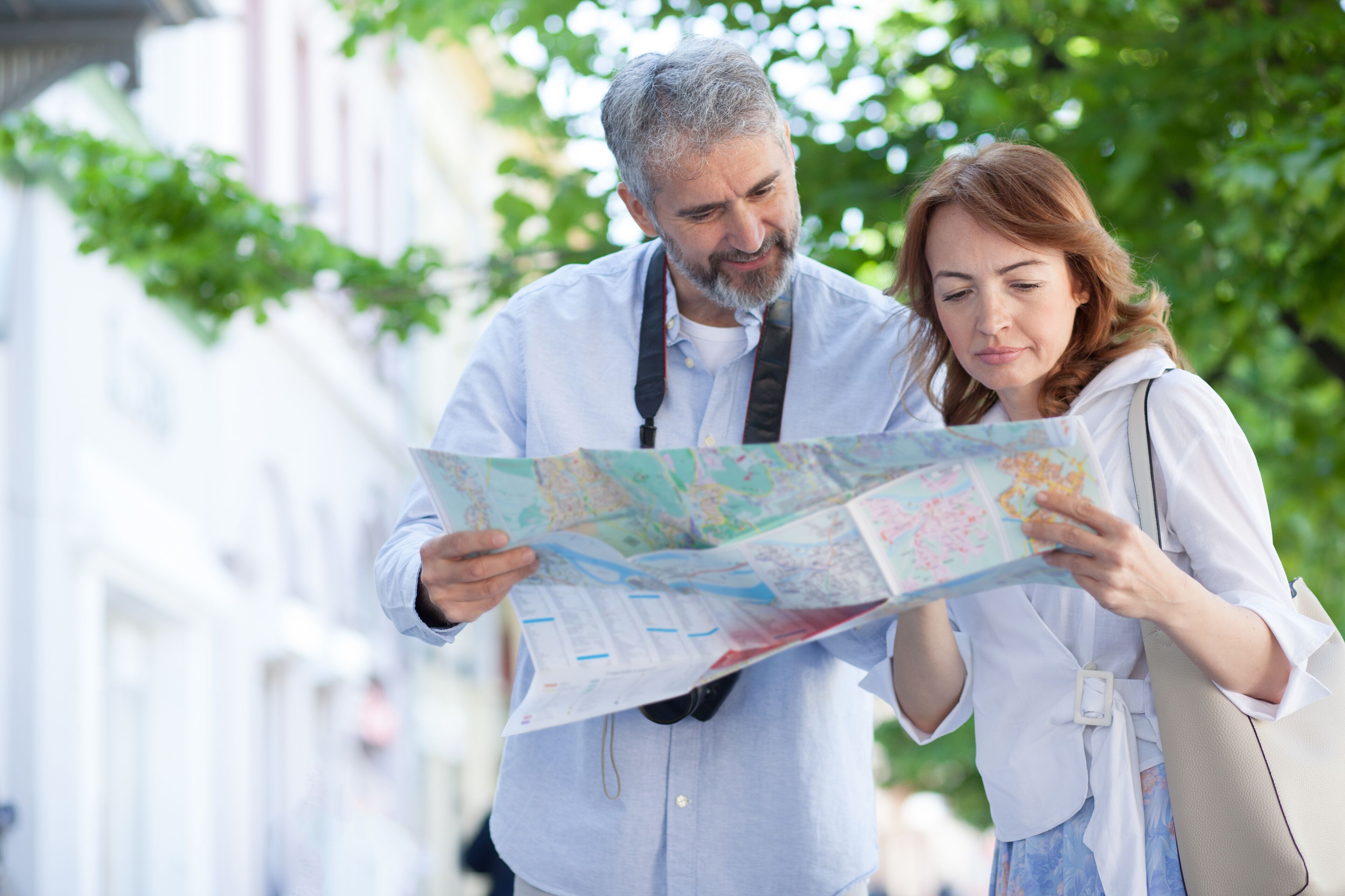 Two people examining a map outdoors.