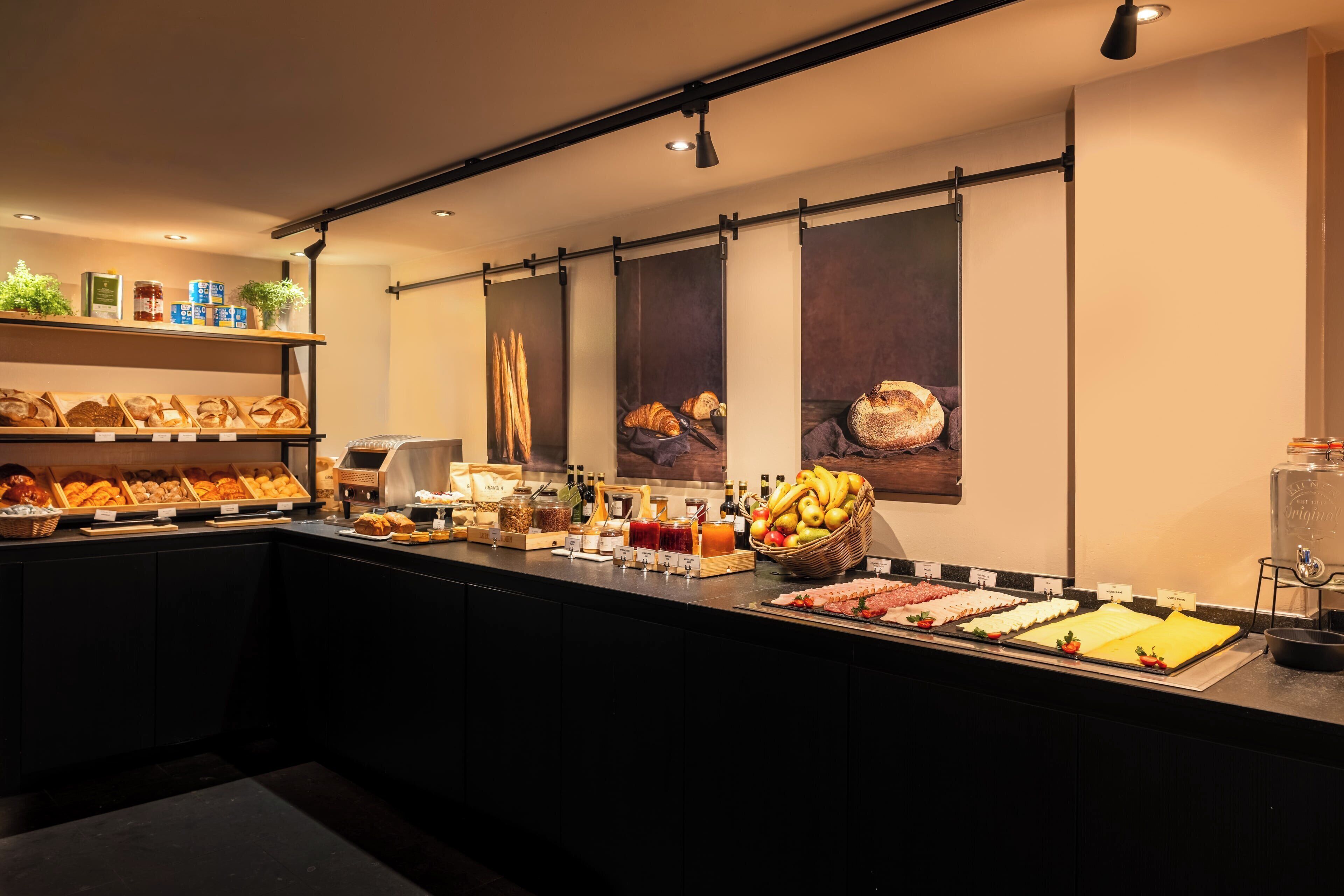 A buffet area with various food items and condiments.