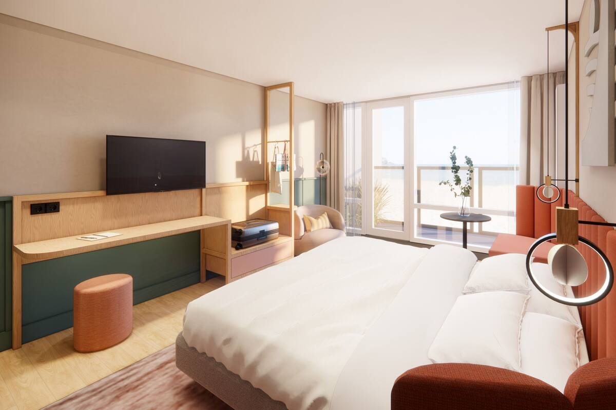A modern hotel room with a bed, a desk, a TV, and a balcony with a view.