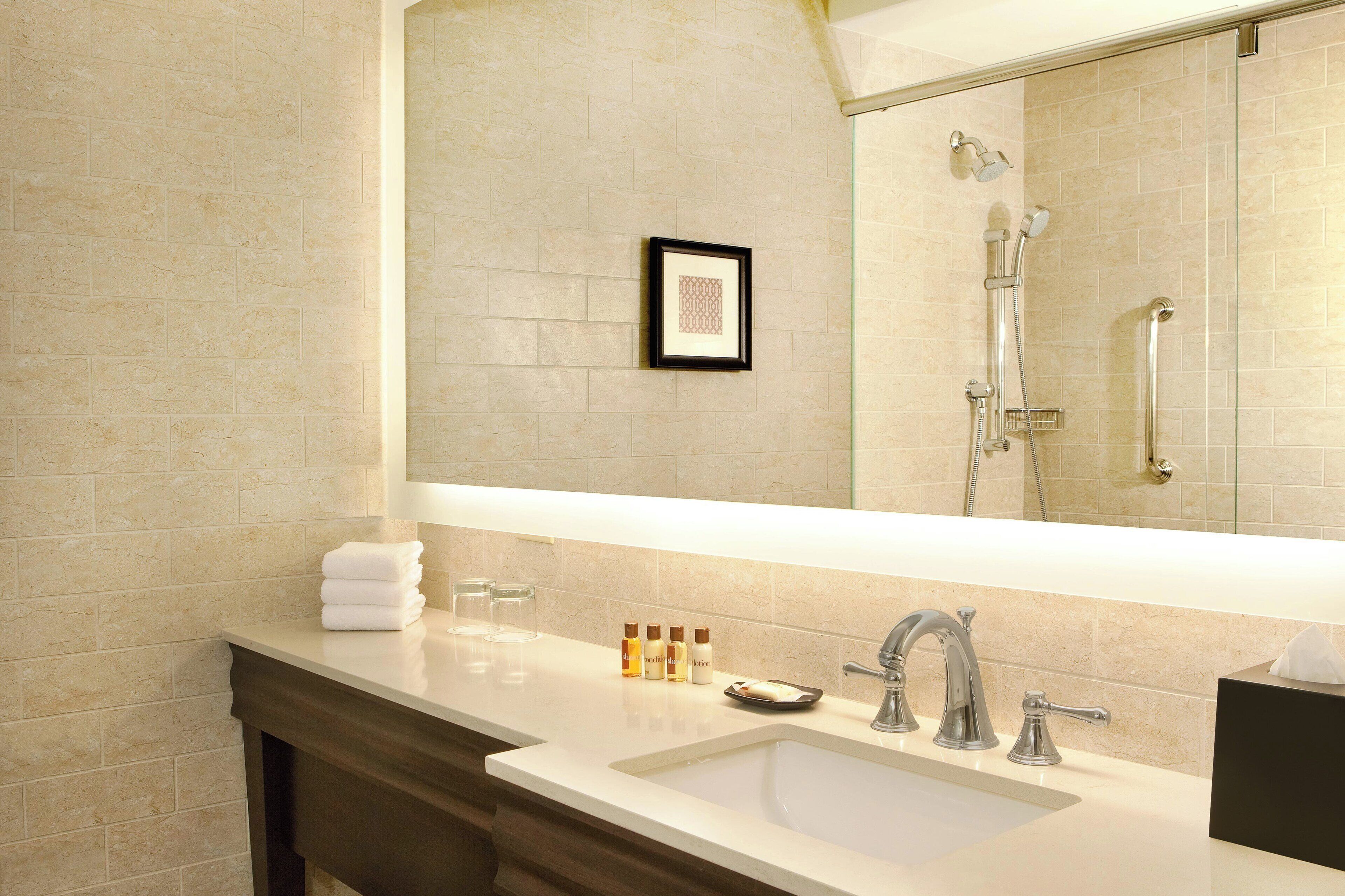 shower, designer toiletries, hair dryer, towels