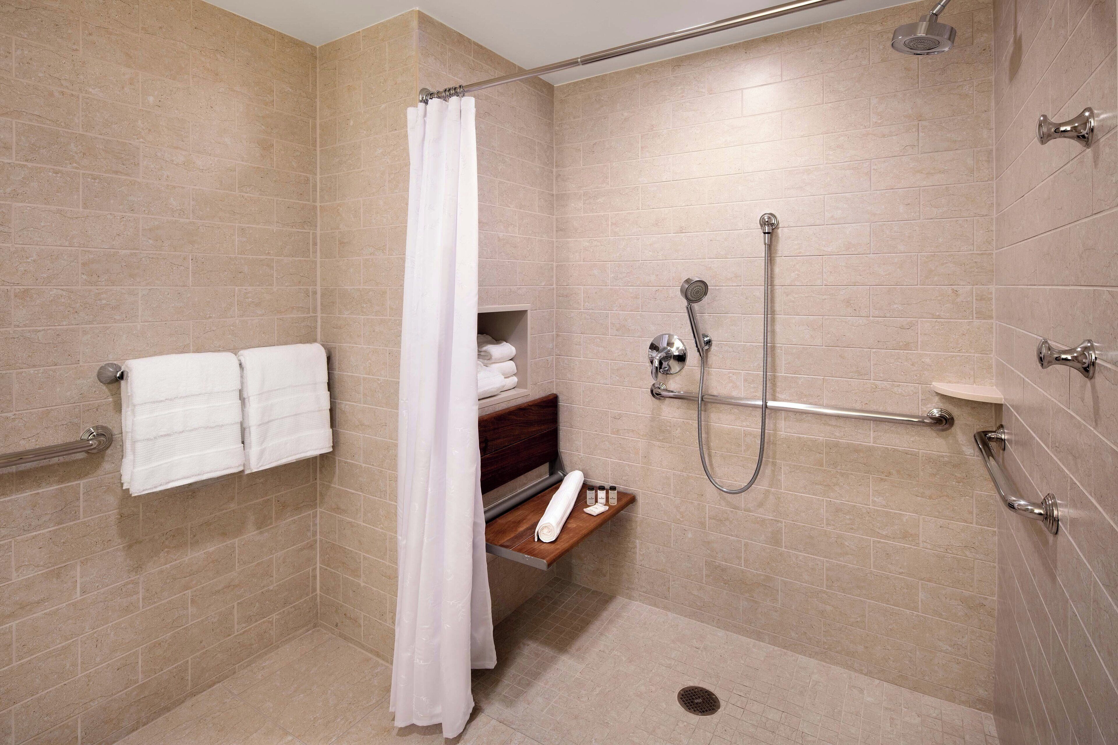 shower, designer toiletries, hair dryer, towels
