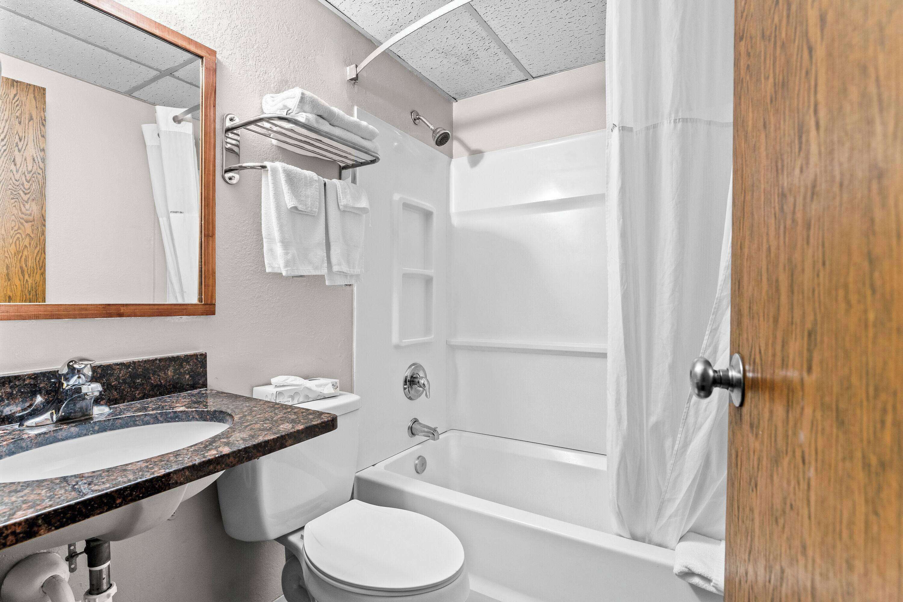 A bathroom with a sink, toilet, and bathtub.