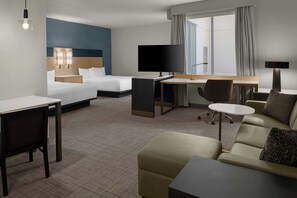 A hotel room with a bed, a desk, a TV, a sofa, and a chair. - Residence Inn by Marriott Claremont (Claremont)