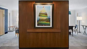 A framed artwork on a wooden panel in a hotel lobby.