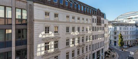 A multi-story building with a classical architectural style, featuring symmetrical windows and decorative moldings.
